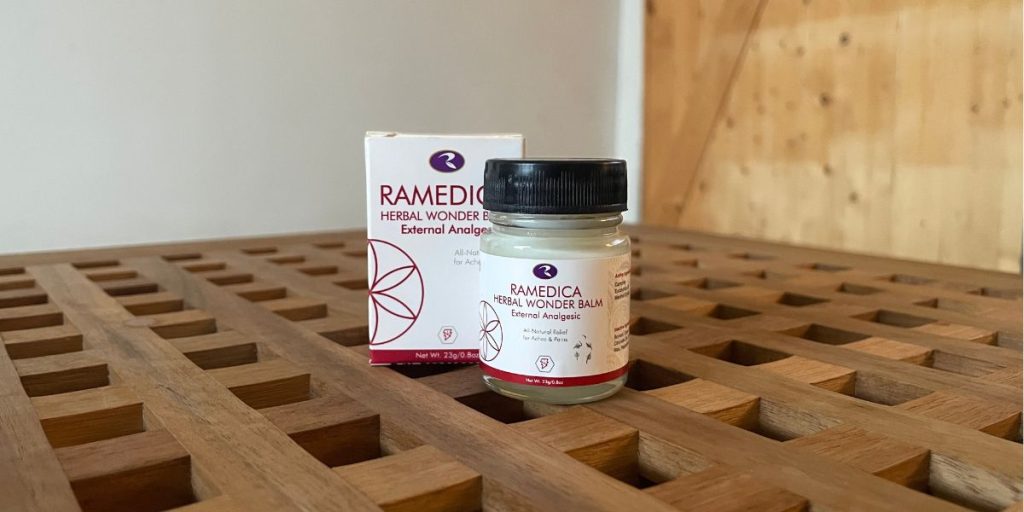 Ramedica Herbal Wonder Balm jar and box displayed on a wooden surface