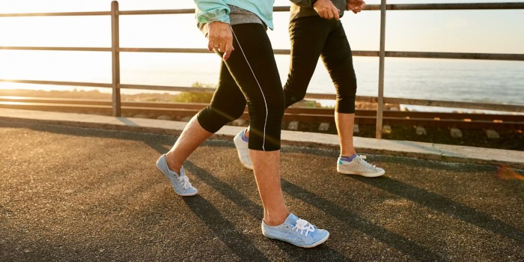 Two people walking outdoors as part of an interval walking fitness routine