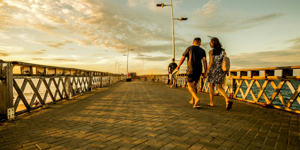 Couple enjoying an evening walk after a meal to support healthy blood sugar, digestion, circulation and joint health